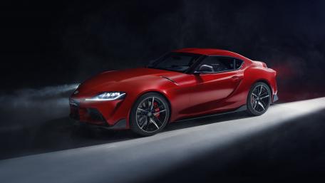 Sleek Red Sports Car in Dramatic Lighting wallpaper
