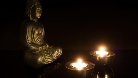Serenity of the Buddha in Candlelight wallpaper