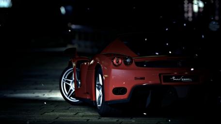Sleek Red Car in Urban Setting at Night wallpaper