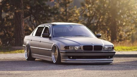 Sleek BMW Sedan on a Sunlit Roadway wallpaper