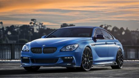 Sleek Blue BMW Against a Sunset Sky wallpaper