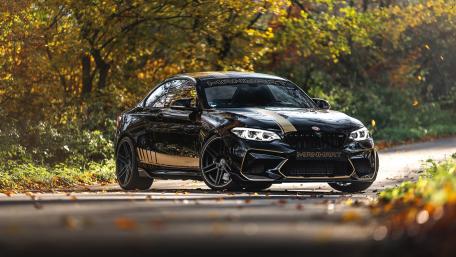 Sleek Black BMW in Autumn Landscape wallpaper