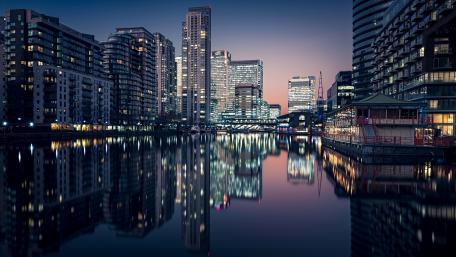 Serene City Lights Reflecting on Water wallpaper
