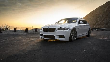 Sleek White BMW Against a Golden Sunset wallpaper