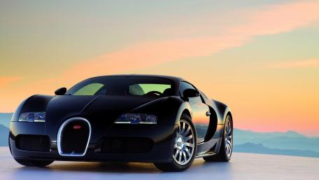 Sleek Elegance of a Black Supercar at Sunset wallpaper