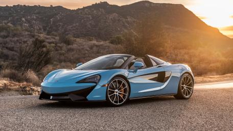 Sleek McLaren Sports Car at Sunset Scene wallpaper