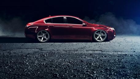 Sleek Red Sedan in Night Atmosphere wallpaper