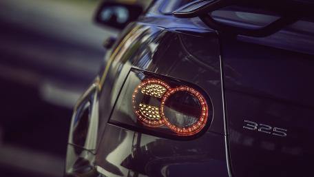 Sleek Evening Glow of a Sports Car Tail Light wallpaper