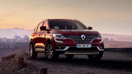 Sleek Red Renault Car Against Scenic Background wallpaper