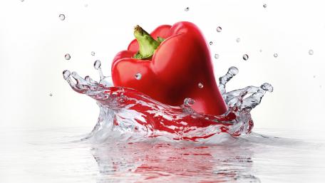 Vibrant Red Pepper Splashing in Water wallpaper