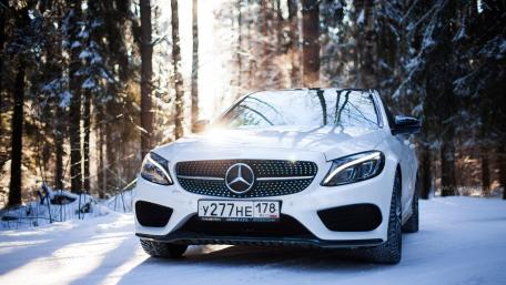 Sleek White Car in Winter Wonderland wallpaper