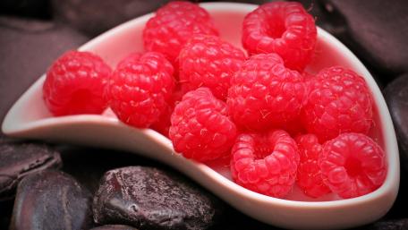 Vibrant Raspberries on Dark Chocolate Background wallpaper