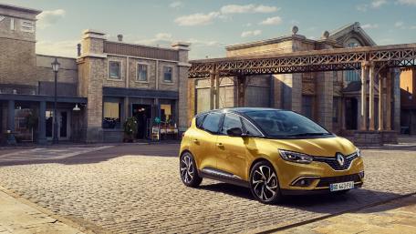 Golden Renault in Charming Historic Setting wallpaper