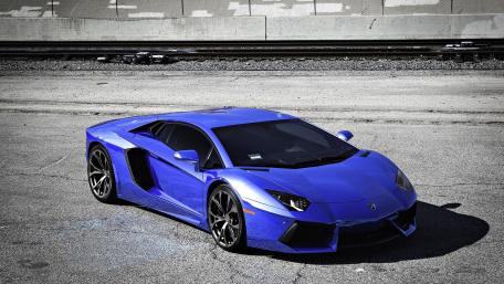 Sleek Blue Lamborghini on Urban Landscape wallpaper