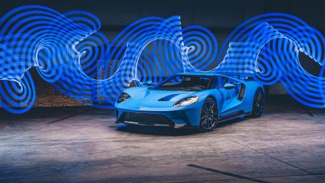 Sleek Blue Supercar with Dynamic Light Trails wallpaper