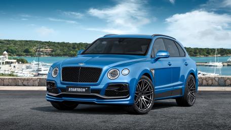 Sleek Luxury SUV Against Coastal Background wallpaper