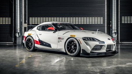 Sleek Racing Car in Vibrant Garage Setting wallpaper