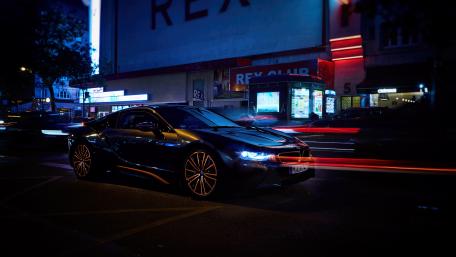 Sleek Night Ride with Vibrant City Lights wallpaper