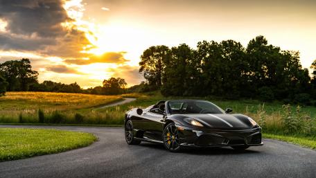 Sleek Black Sports Car at Sunset wallpaper