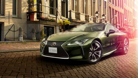 Luxurious Green Lexus LC500h on Cobblestone Street wallpaper
