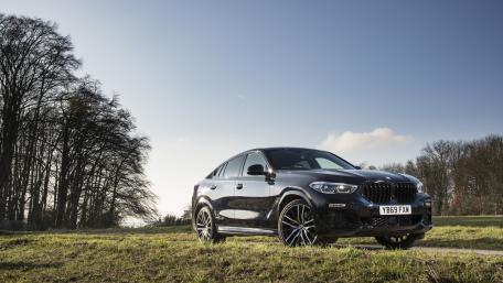 Sleek BMW X6 in Nature's Embrace wallpaper