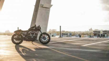 Sleek Black Motorcycle Under Sunset Glow wallpaper
