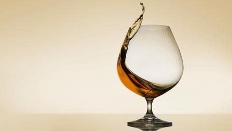Elegant Swirl of Whiskey in Glass wallpaper