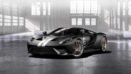 Sleek Black Sports Car in Industrial Setting wallpaper