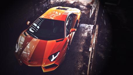 Stunning Orange Lamborghini in Abandoned Warehouse wallpaper
