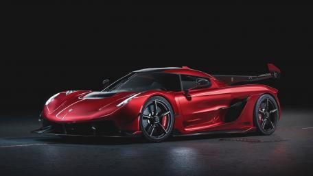 Sleek Red Supercar in a Dark Environment wallpaper