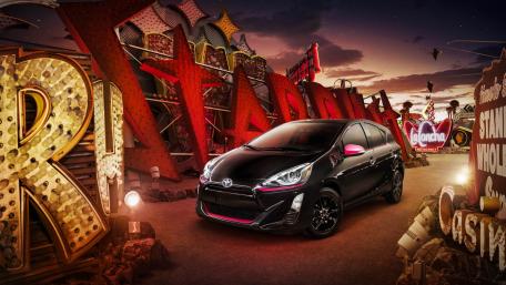 Sleek Black Car in Neon Sign Paradise wallpaper