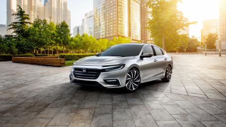 Sleek Silver Sedan in Urban Landscape wallpaper