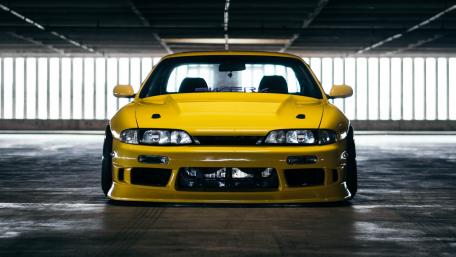 Vibrant Yellow Sports Car in Urban Setting wallpaper