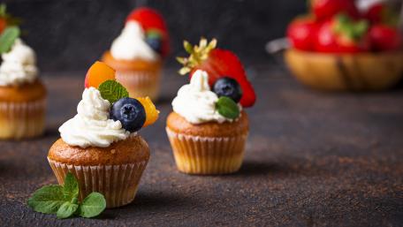 Delightful Mini Cupcakes with Fresh Fruits and Creamy Topping wallpaper