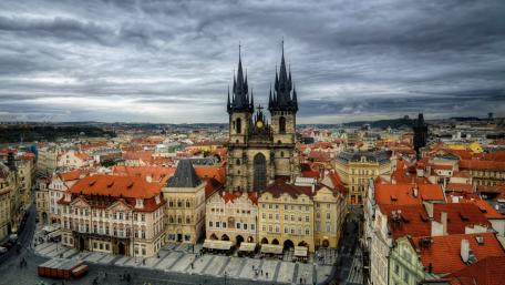 Prague's Majestic Cityscape Under Ominous Skies wallpaper