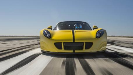 Vibrant Yellow Sports Car in Motion wallpaper