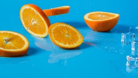 Refreshing Orange Slices on a Blue Background wallpaper