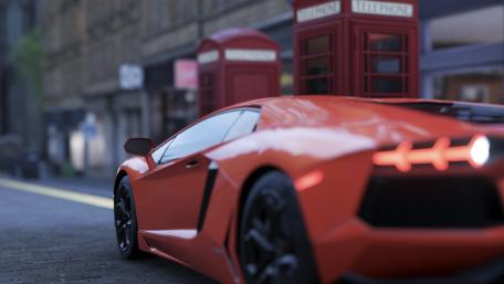 Sleek Red Supercar in the Cityscape wallpaper