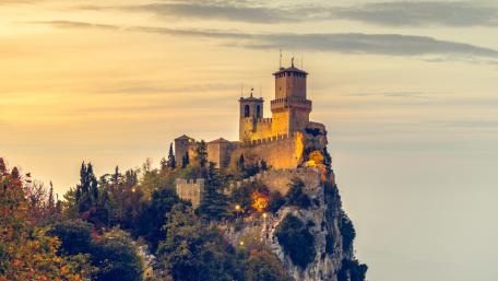 Majestic Castle on a Mountainside Glow wallpaper