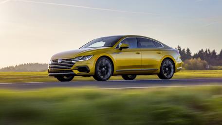 Sleek Yellow Sedan on a Scenic Drive wallpaper