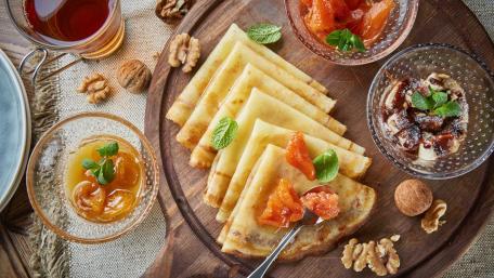 Delicious Crepes with Sweet Toppings and Fresh Mint Leaves wallpaper