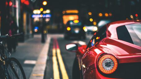 Sleek Red Sports Car in Urban Nightscape wallpaper