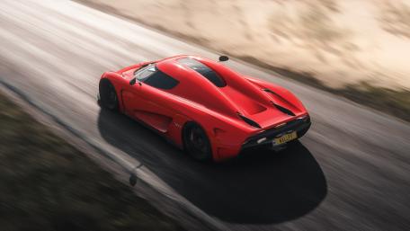 Sleek Red Supercar in Motion wallpaper