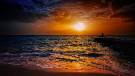 Serene Sunset Over a Beach Pier wallpaper