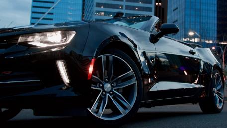 Sleek Black Convertible in Urban Setting wallpaper