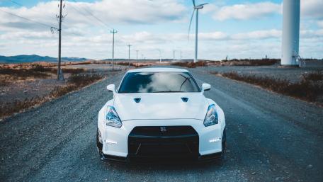 Sleek White Sports Car in Scenic Landscape wallpaper