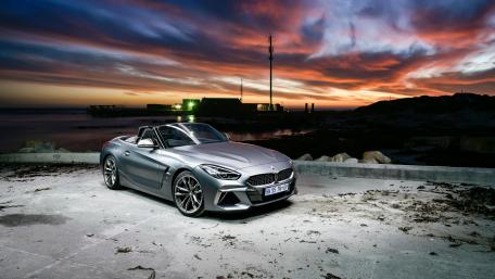 Sleek BMW Z4 Against a Stunning Sunset Sky wallpaper