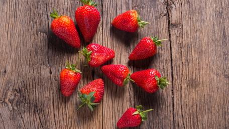 Fresh Juicy Strawberries on Rustic Wood Background wallpaper