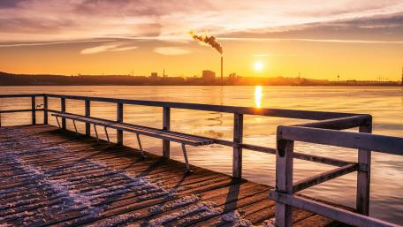 Serene Sunrise Over Industrial Shores wallpaper