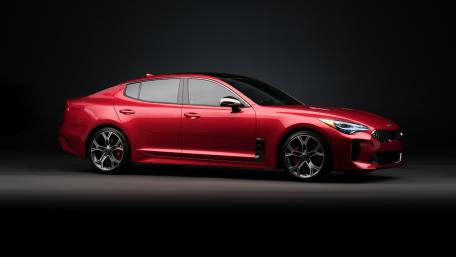 Sleek Red Car Showcasing Modern Design and Power wallpaper